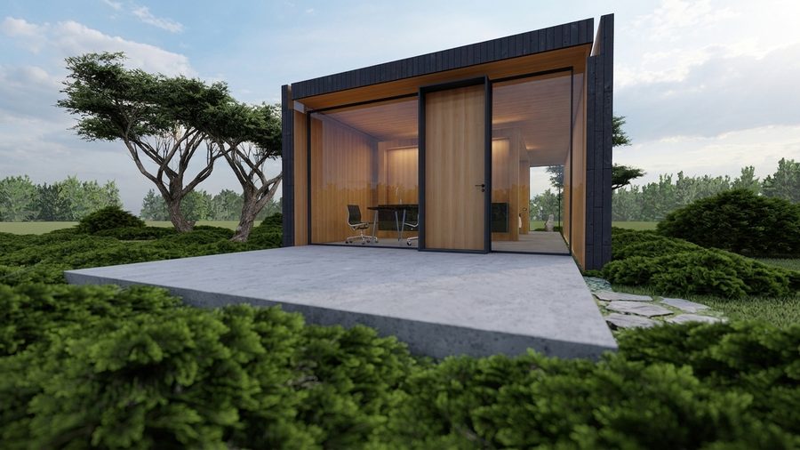 Het tiny house overdag, met de houten gevel en een pad naar de entree