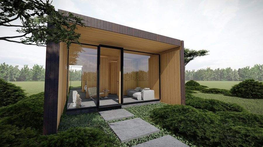 Het tiny house met openslaande puien naar een terras van betontegels