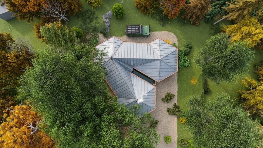 De drie volumes van de woning van bovenaf gezien, tussen de bomen op het perceel