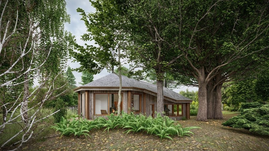 De woning gezien tussen de volwassen bomen op het perceel